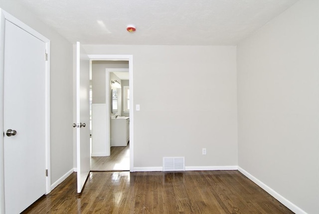 spare room featuring dark hardwood / wood-style floors