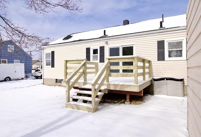 view of snow covered rear of property