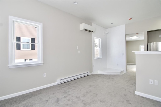 spare room featuring a baseboard radiator, light carpet, and a wall unit AC