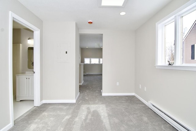 unfurnished room featuring a baseboard radiator, light carpet, and electric panel