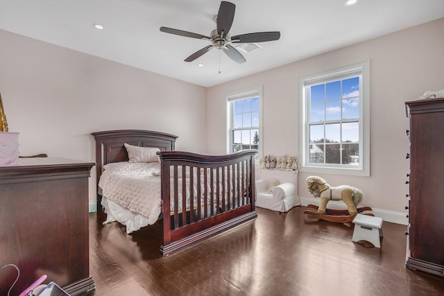 bedroom with ceiling fan and dark hardwood / wood-style flooring