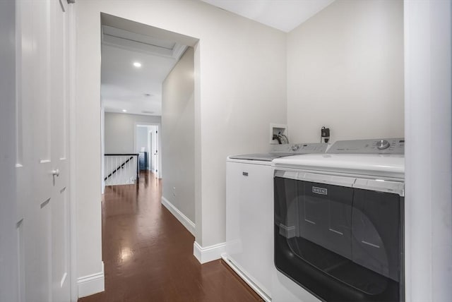 laundry area with dark hardwood / wood-style floors and washing machine and clothes dryer