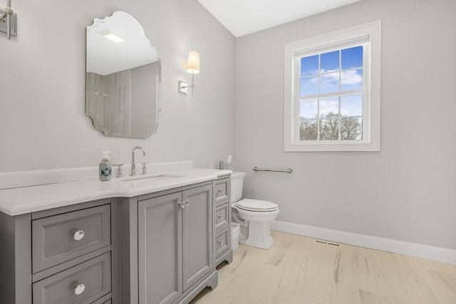 bathroom featuring toilet and vanity