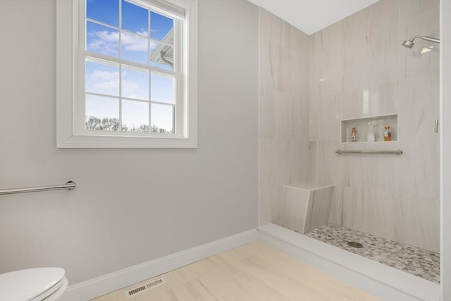 bathroom featuring toilet and a shower