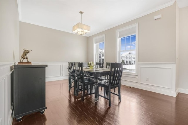 dining space featuring dark hardwood / wood-style flooring and ornamental molding