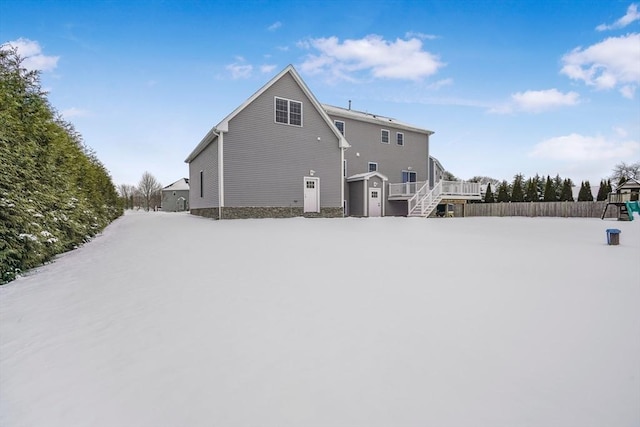 view of snow covered rear of property