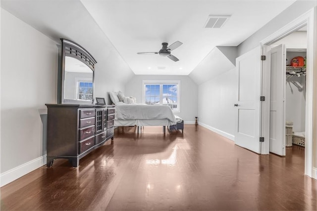 bedroom with a closet, ceiling fan, dark hardwood / wood-style flooring, and lofted ceiling