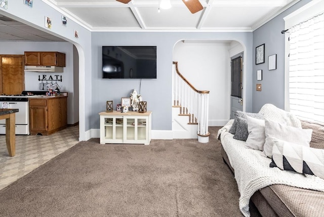 living room featuring crown molding, ceiling fan, coffered ceiling, and light carpet