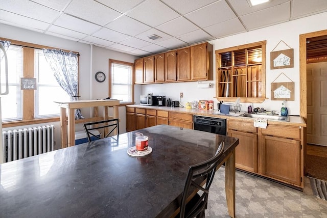 kitchen featuring a paneled ceiling, radiator heating unit, dishwasher, and sink