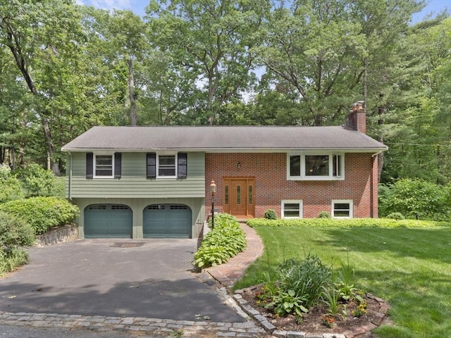 5 Cyr Cir, Andover, MA 01810 - bi-level home featuring a chimney, driveway, an attached garage, a front lawn, and brick siding