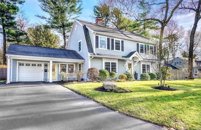 view of front of home with a front lawn and a garage