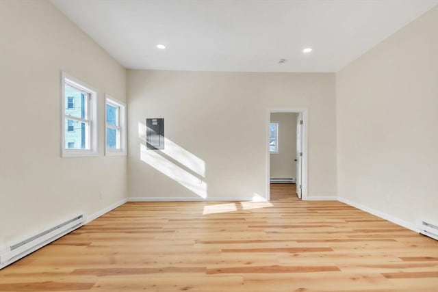 empty room with wood finished floors, baseboards, recessed lighting, a baseboard heating unit, and baseboard heating