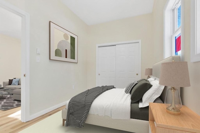 bedroom featuring a closet, baseboards, and wood finished floors