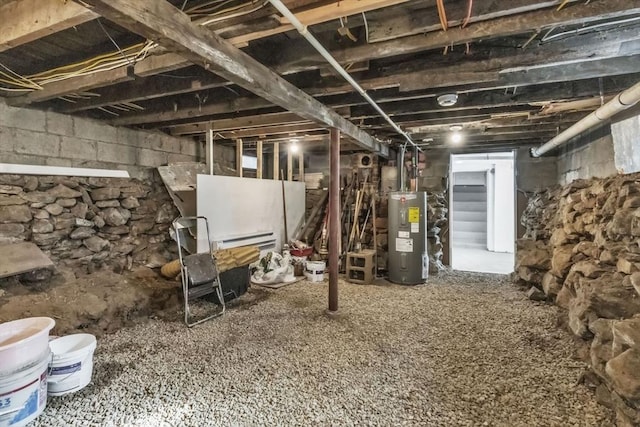 unfinished basement featuring water heater