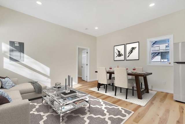 living room featuring recessed lighting, wood finished floors, and baseboards