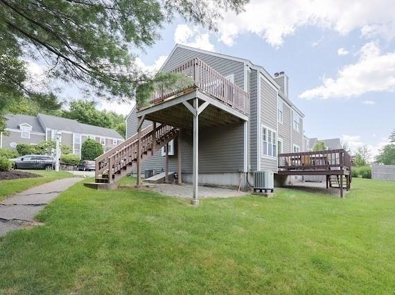 14 Shaw Farm Rd Unit 14, Canton, MA 02021 - view of side of home featuring a wooden deck, stairs, a yard, and a chimney