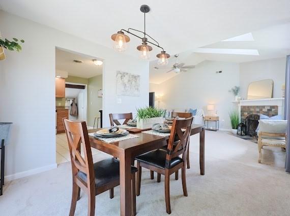 14 Shaw Farm Rd Unit 14, Canton, MA 02021 - dining space featuring a fireplace with flush hearth, ceiling fan, light colored carpet, and lofted ceiling