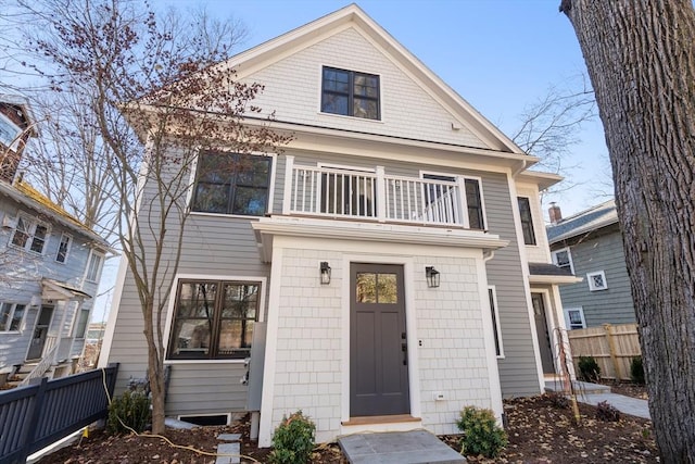view of front of house featuring a balcony