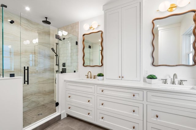 bathroom with tile patterned flooring, vanity, and walk in shower