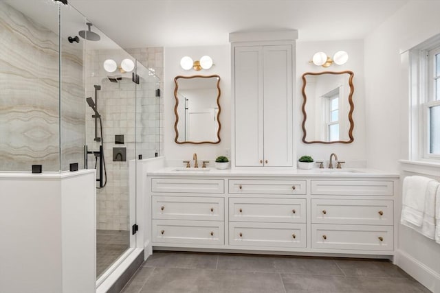 bathroom with tile patterned floors, vanity, and a shower with shower door