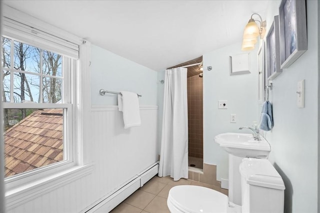full bathroom with wainscoting, toilet, tile patterned floors, a shower stall, and a baseboard heating unit