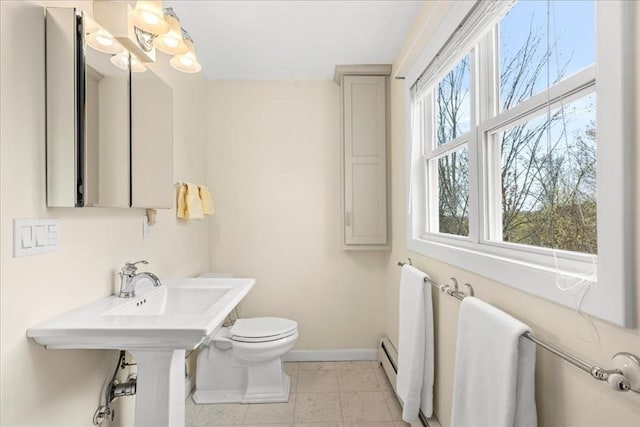 bathroom featuring baseboards and toilet
