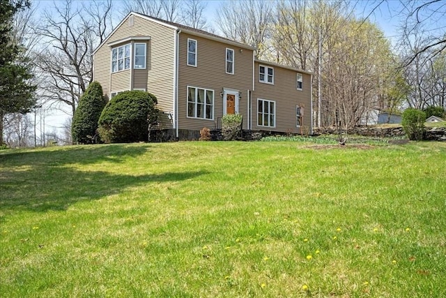back of house featuring a lawn