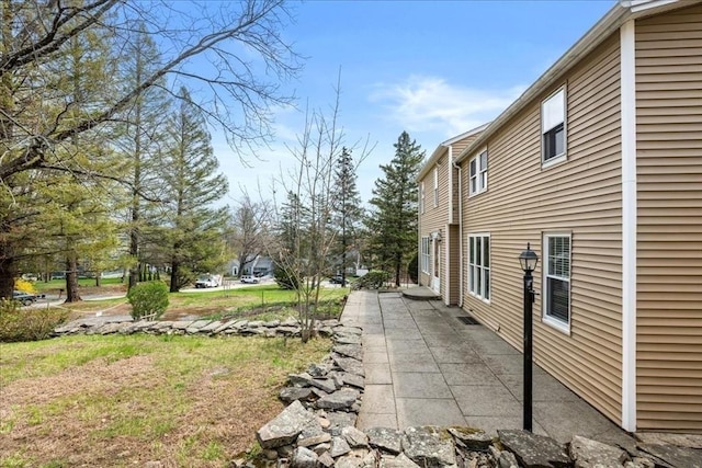 view of property exterior with a patio area
