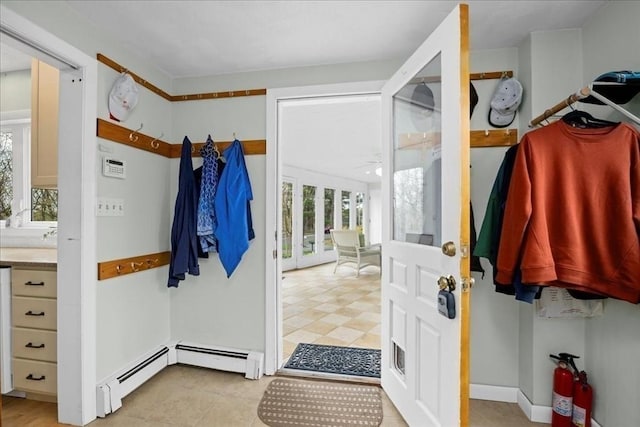 mudroom featuring a baseboard radiator and a wealth of natural light