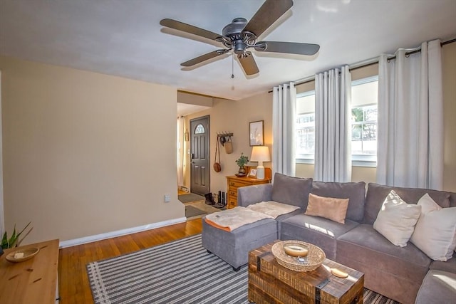 living room featuring hardwood / wood-style floors and ceiling fan