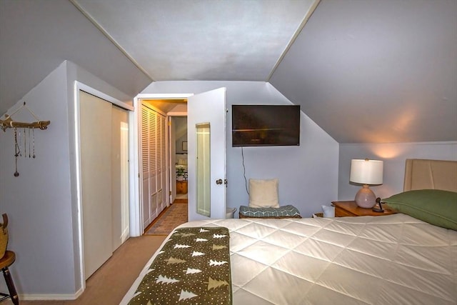 carpeted bedroom with vaulted ceiling