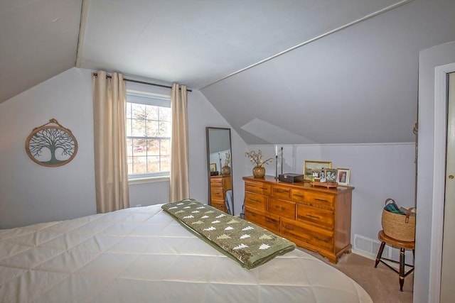 bedroom with vaulted ceiling and carpet flooring