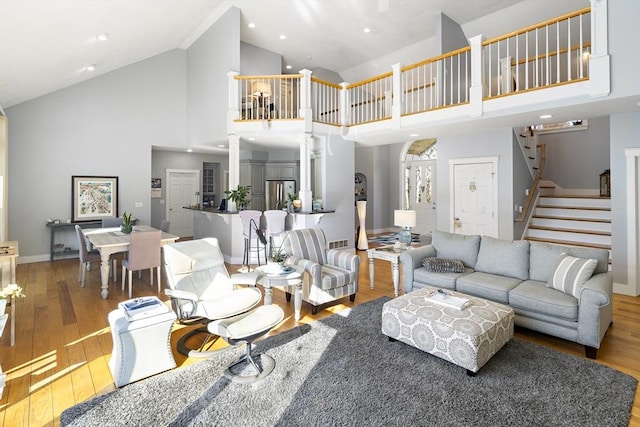 living room featuring hardwood / wood-style flooring and high vaulted ceiling