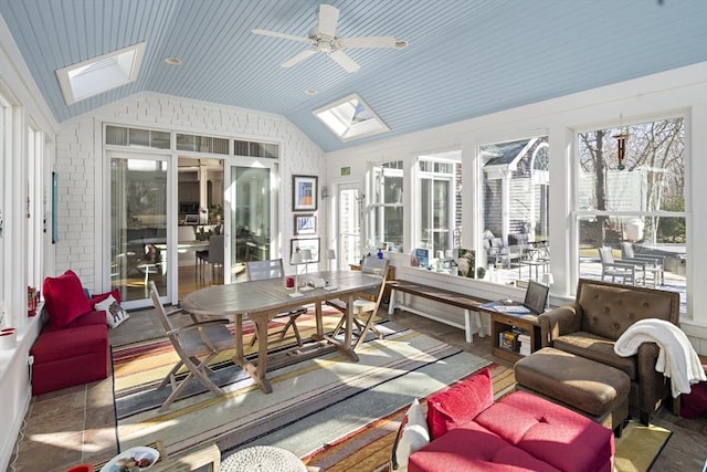 sunroom / solarium featuring vaulted ceiling with skylight and ceiling fan