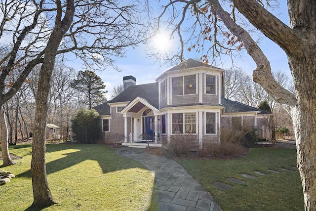 view of front of house with a front lawn and a sunroom