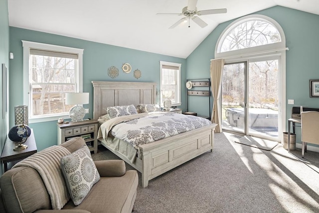 carpeted bedroom with multiple windows, lofted ceiling, and access to outside