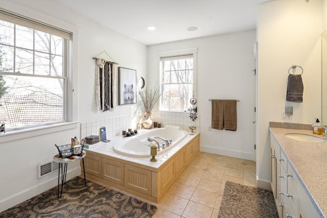 bathroom featuring vanity, a bath, and tile patterned flooring