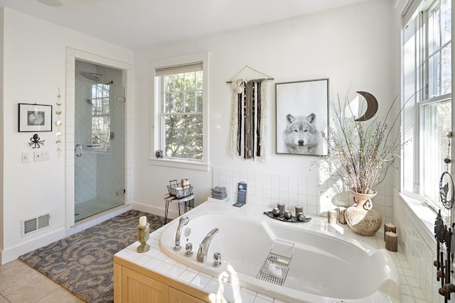 bathroom featuring tile patterned flooring and plus walk in shower