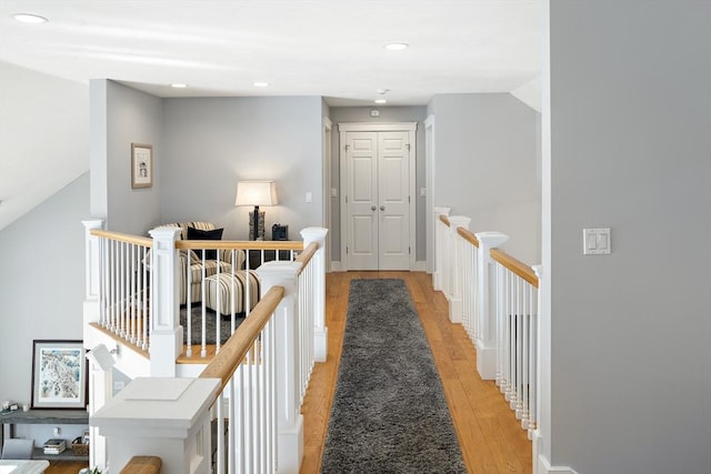 hallway with light hardwood / wood-style floors