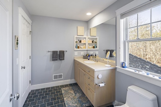 bathroom featuring vanity and toilet