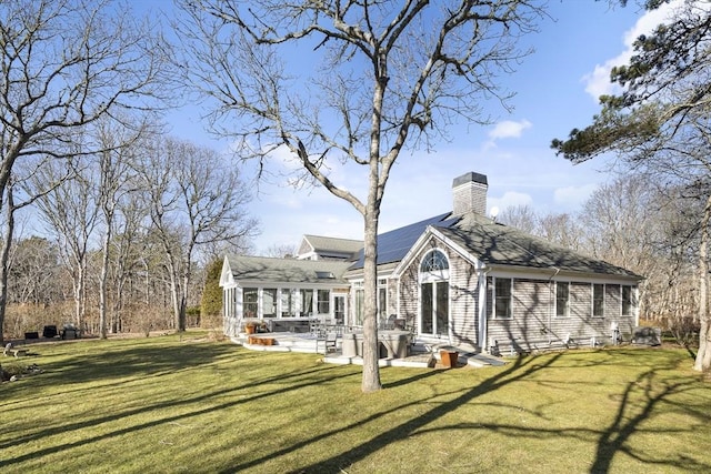 back of house with a yard and a patio