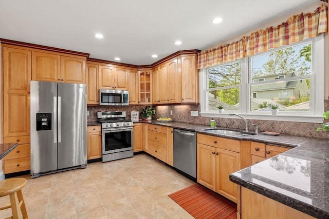 43 Chilton St, Belmont, MA 02478 - kitchen featuring stainless steel appliances, a sink, dark stone countertops, tasteful backsplash, and glass insert cabinets