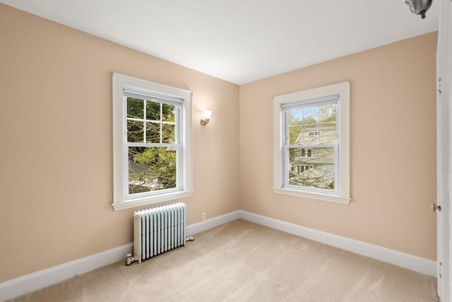 43 Chilton St, Belmont, MA 02478 - empty room featuring radiator heating unit, plenty of natural light, light colored carpet, and baseboards
