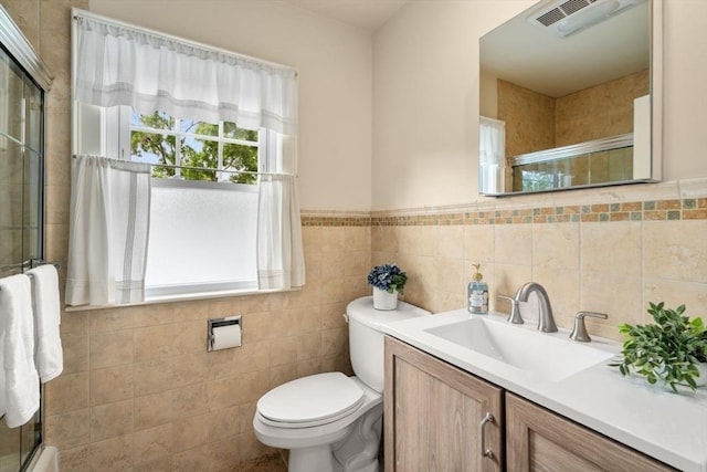 43 Chilton St, Belmont, MA 02478 - bathroom featuring toilet, vanity, a shower with door, tile walls, and a wainscoted wall