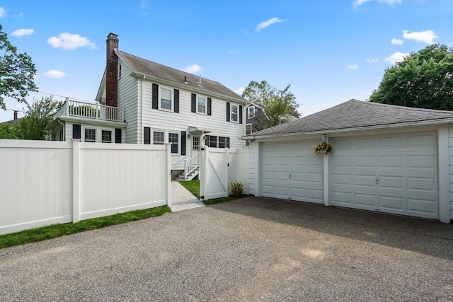 43 Chilton St, Belmont, MA 02478 - view of front of home featuring a chimney, an outbuilding, and a garage