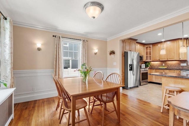 43 Chilton St, Belmont, MA 02478 - dining space with light wood finished floors, a wainscoted wall, and crown molding