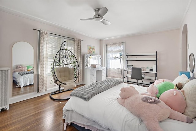 9 Prospect St, Winchester, MA 01890 - bedroom with ornamental molding, wood finished floors, arched walkways, ceiling fan, and baseboards