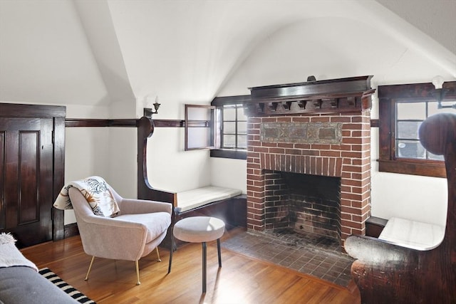 9 Prospect St, Winchester, MA 01890 - living area featuring wood finished floors, vaulted ceiling, and a fireplace