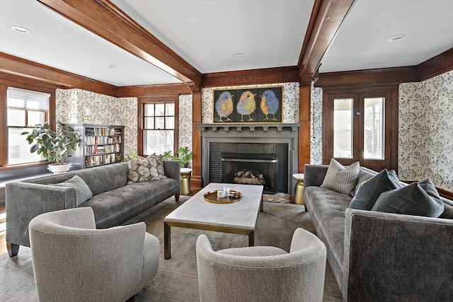 9 Prospect St, Winchester, MA 01890 - living room featuring healthy amount of natural light, beam ceiling, wallpapered walls, a brick fireplace, and crown molding