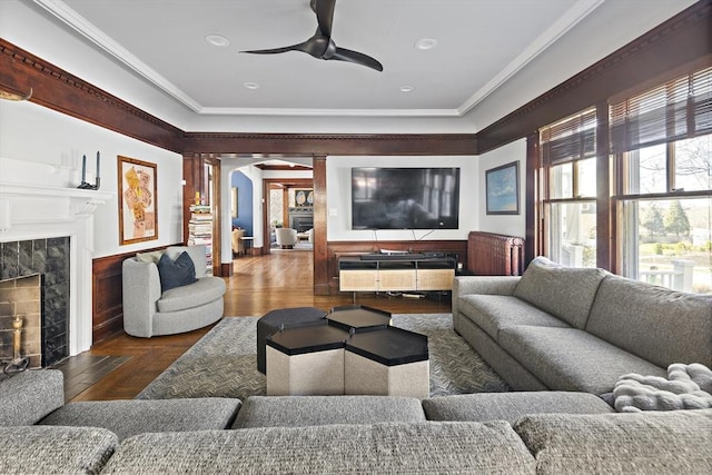 9 Prospect St, Winchester, MA 01890 - living room featuring a fireplace, ceiling fan, crown molding, decorative columns, and arched walkways